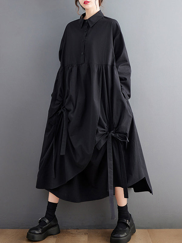 Robe chemise boutonnée plissée nouée coupe trapèze, à manches longues, à poches, à col revers, couleur unie
