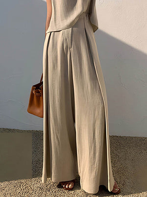 Pantalon ample plissé taille haute, à empiècements, couleur unie