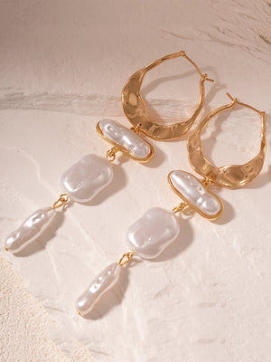 Boucles d'oreilles géométriques à pompons