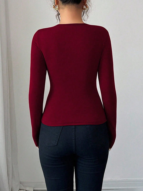T-shirt à manches longues, coupe près du corps, à empiècements, à col asymétrique, couleur unie